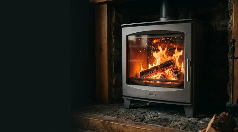 A fire burning in a stove with a glass door