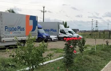 Three delivery vans in Promo Plus livery, parked
